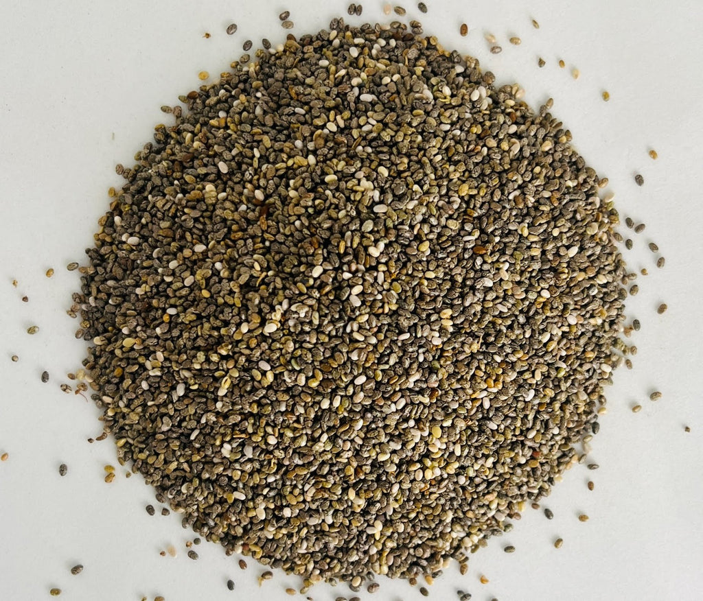 Gros plan macro ultra-détaillé sur la texture marbrée et la pureté des graines de chia bio d'Orianza.
