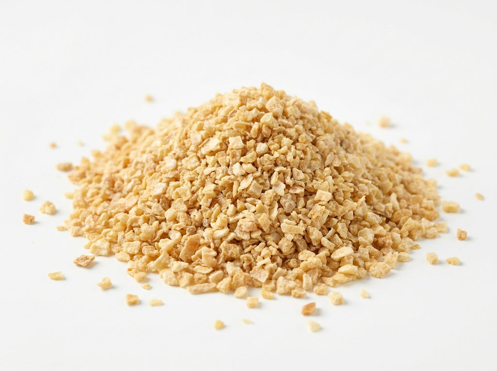 Gros plan herboriste sur les petits grains réguliers d'oignon déshydraté, riches en sucrosité naturelle.